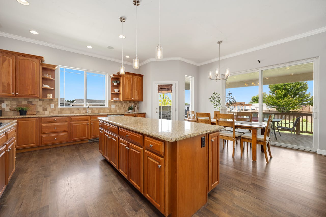 Bright and spacious kitchen with wooden cabinets and a dining area.